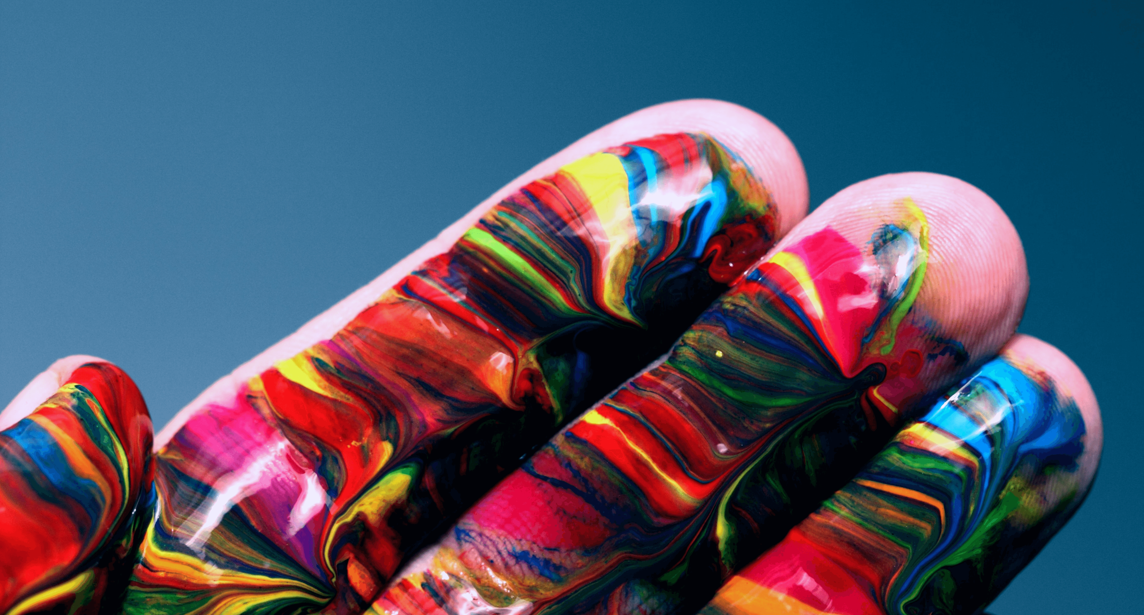 A hand with rainbow paint on it